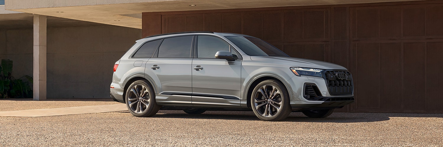 Silver Q7 parked under an awning at dusk