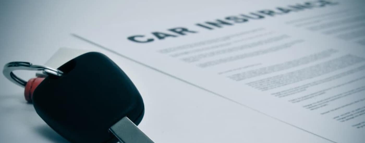 Car key on insurance paperwork