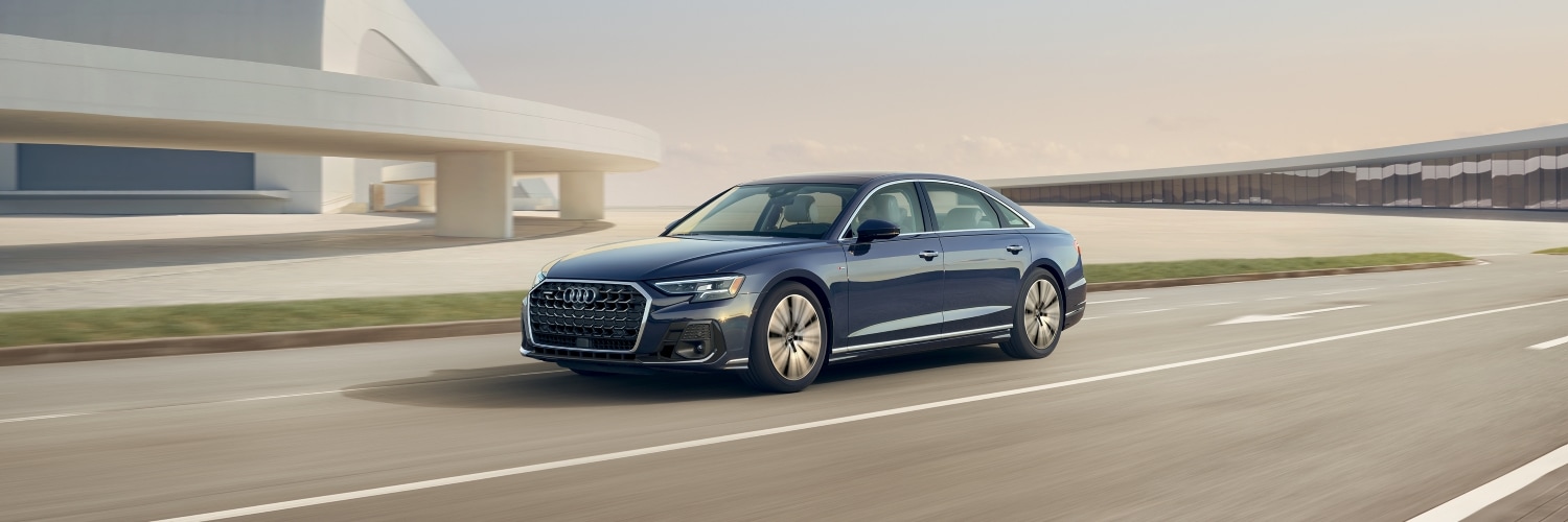 Blue Audi A8 driving down a highway