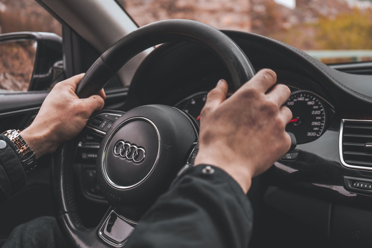 Mans Hands on a Steering Wheel.jpg
