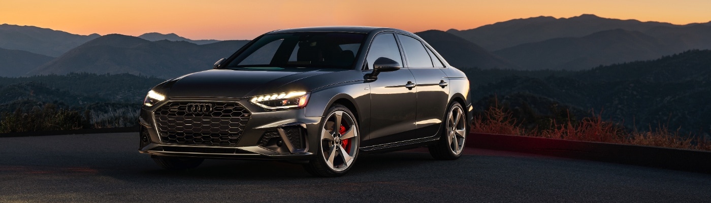 Audi A4 parked in front of mountain skyline