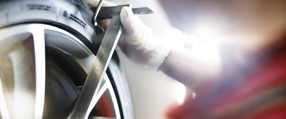 Audi Pensacola Mechanic Performing a Wheel Alignment in Pensacola, FL