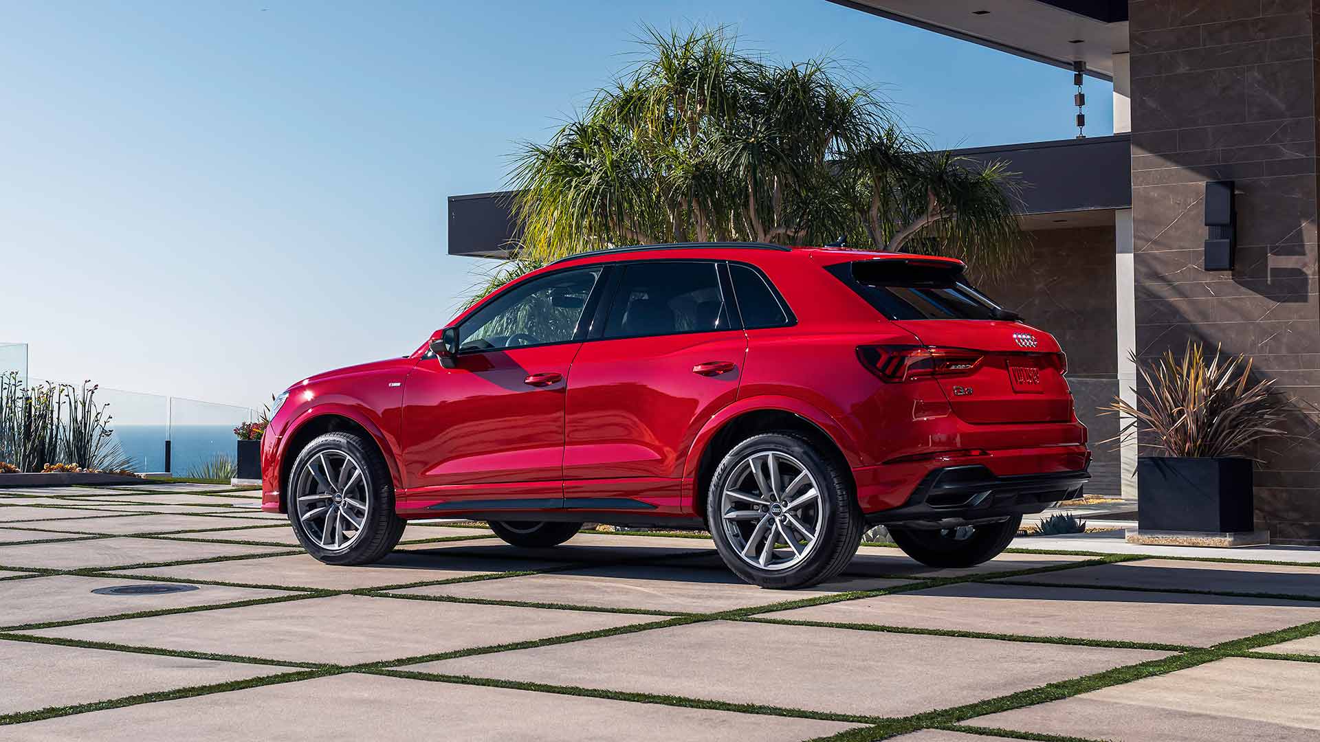2023 Audi Q3 2023 Audi Q3 45 TFSI in Red, parked in front of a home