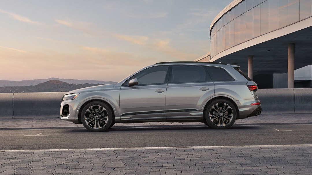 Side view of Audi Q76 at a standstill on a paved road