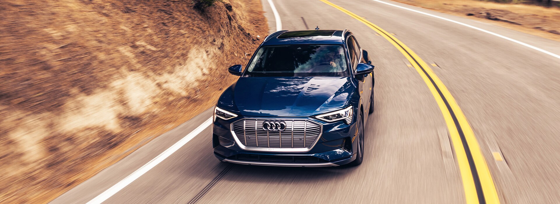 2022 Audi e-tron driving on forest road.