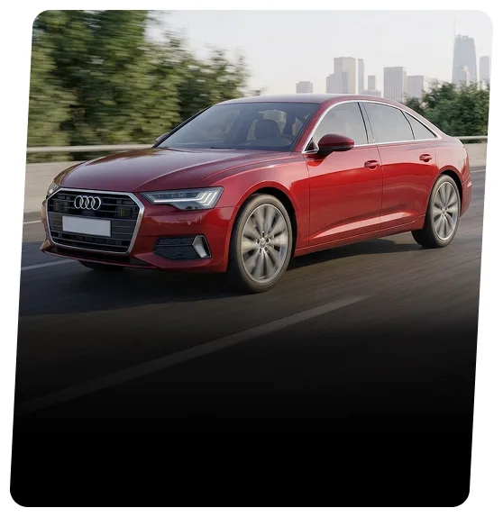 Red Audi sedan driving on a highway lined with trees