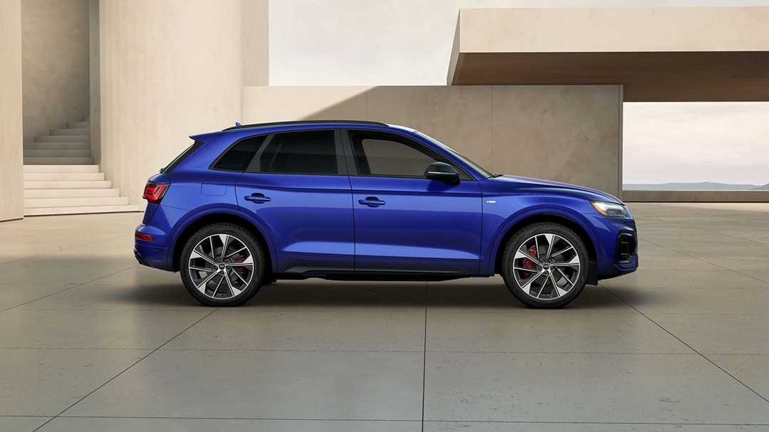 Side view of Audi Q5 2025 parked in front of a luxury building