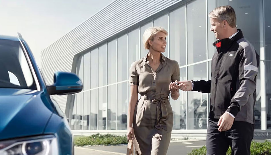 Audi Technician handing lady key to her Audi