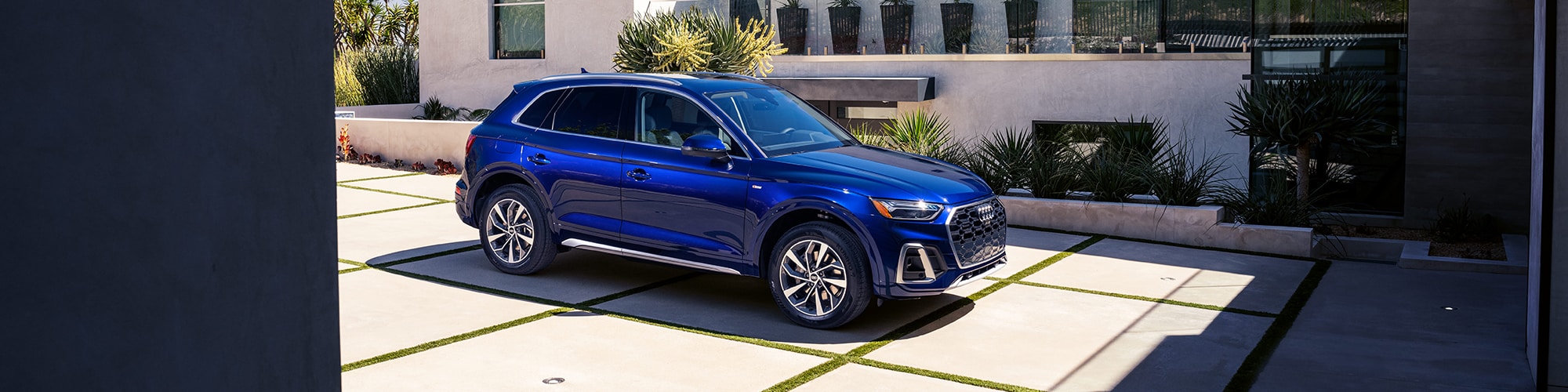 Blue New 2023 Audi Q5 SUV parked.