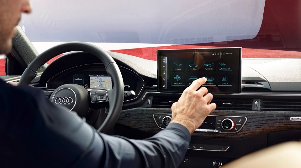 New 2023 Audi A4 Driver Navigating the LCD touchscreen.