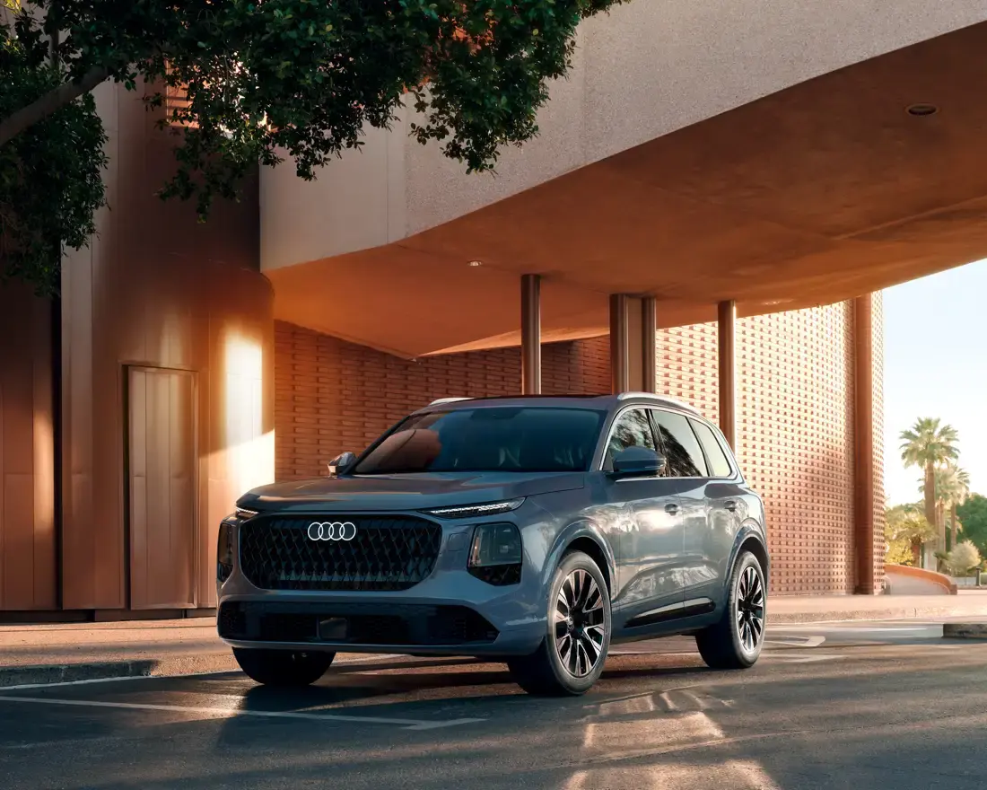 2027 Audi Q7 parked beneath a modern canopy in evening light