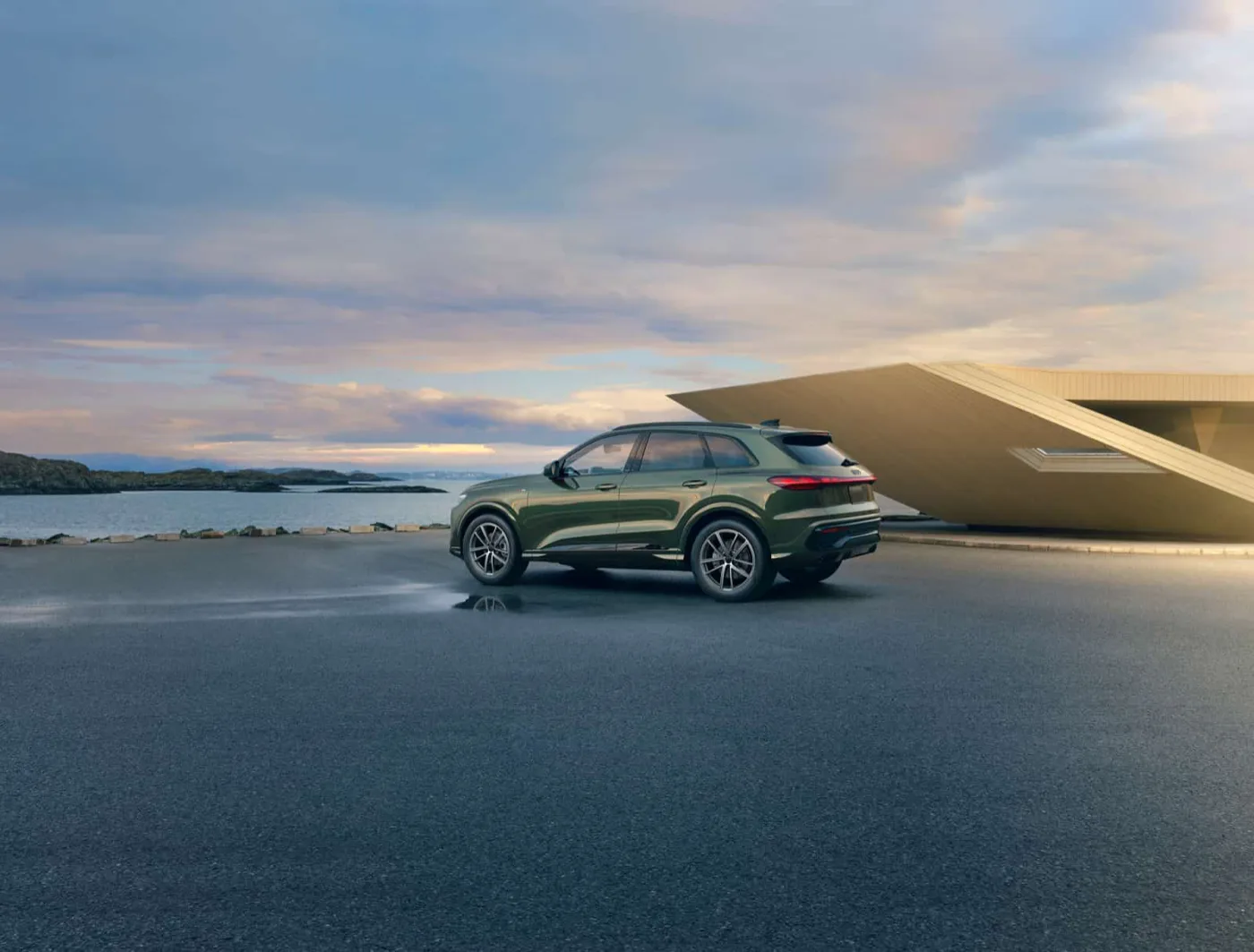 2026 Audi Q5 rear profile parked on a waterfront terrace at dusk