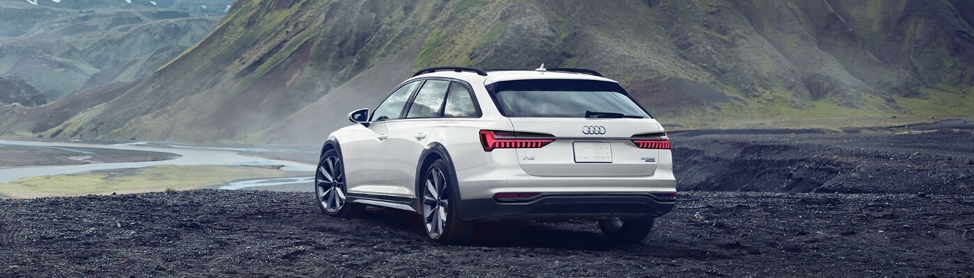 Audi A6 allroad wagon parked in front of mountain terrain
