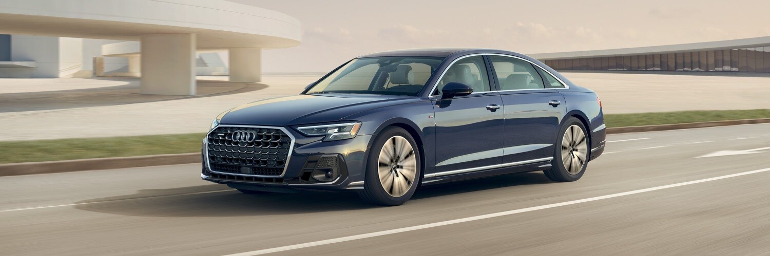 Blue Audi A8 driving on a highway