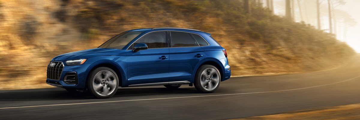 Audi Q5 driving by a hill