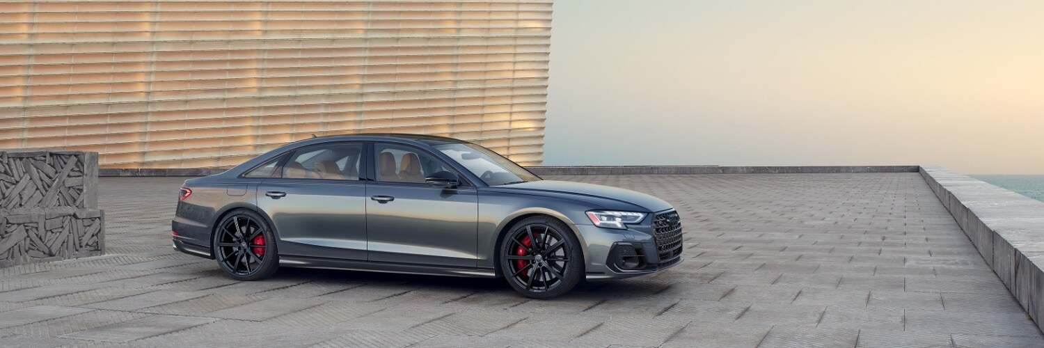 Profile of Audi S8 parked on modern roof top overlooking the ocean