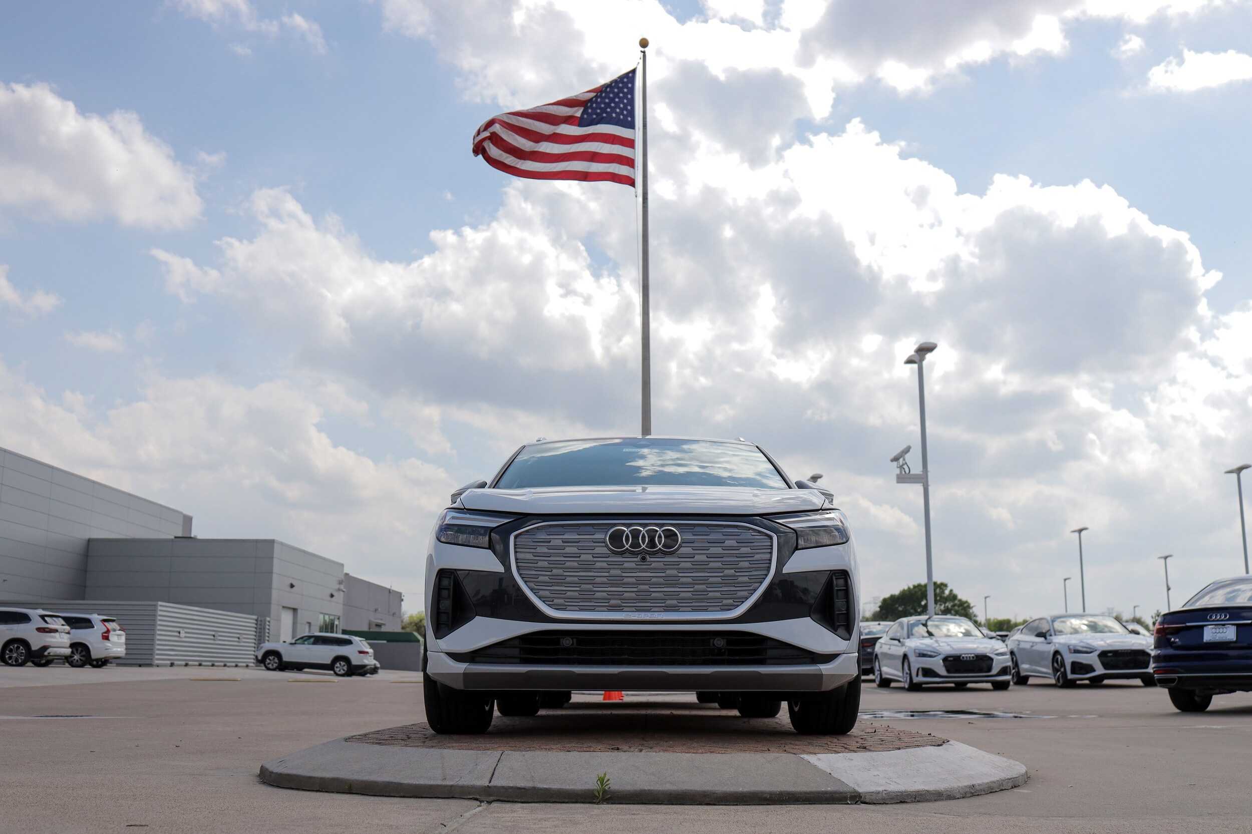 Audi West Houston Audi West Houston with an American Flag in the background