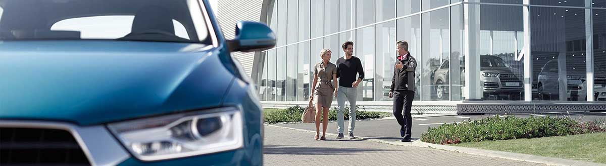Audi specialist walking couple to their Audi.