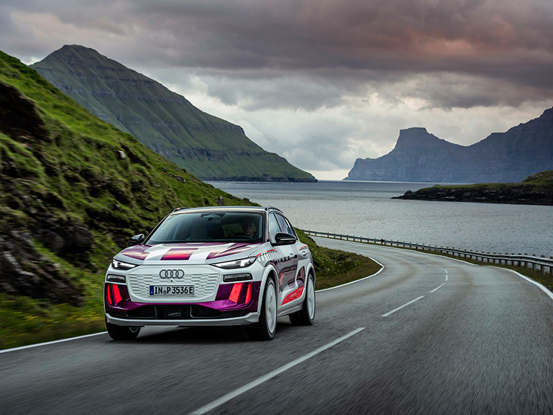2023 Audi Q6 e-tron on windng mountain road by lake