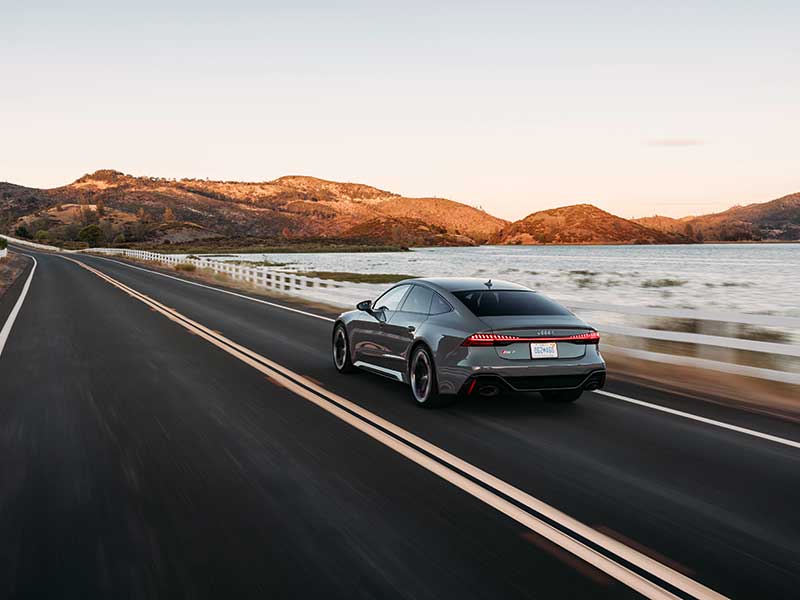 2024 Audi RS 7 Sportback Performance rear driving by lake