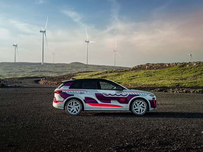 2023 Audi Q6 e-tron on road with windmills sideview