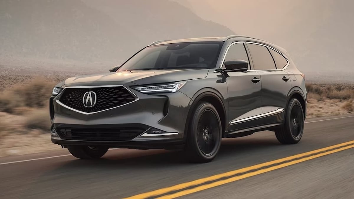 2024 Acura MDX driving down a road