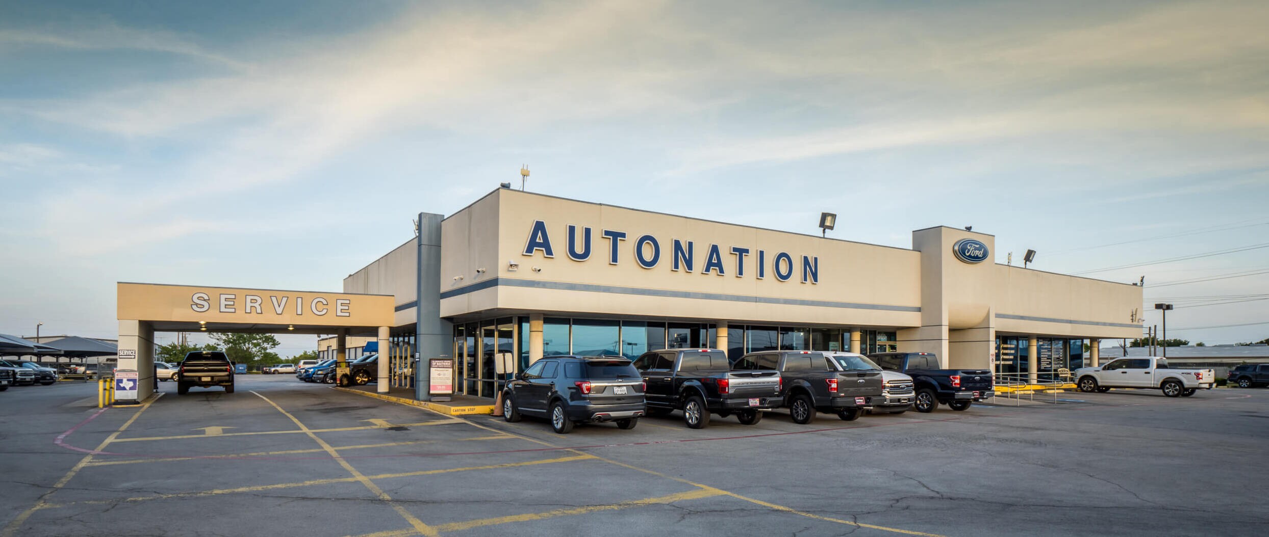 AutoNation Ford Burleson exterior with cars parked in front of building