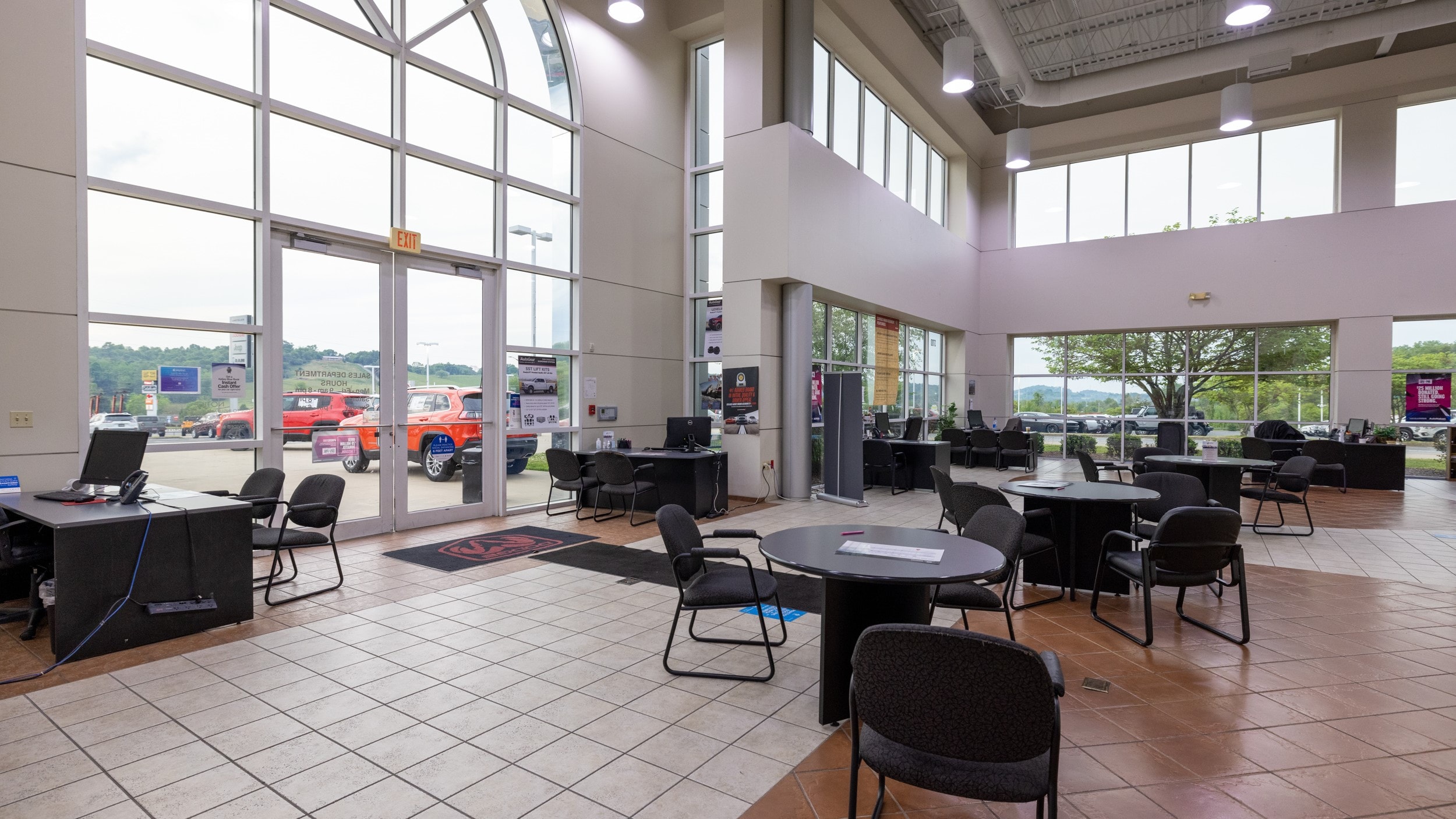 Lobby of AutoNation Chrysler Dodge Jeep Ram & FIAT Johnson City photo of several round tables surrounded by chairs