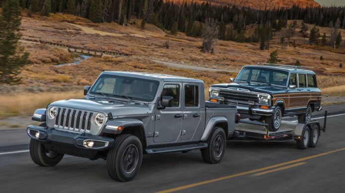 Jeep Gladiator towing a vintage jeep