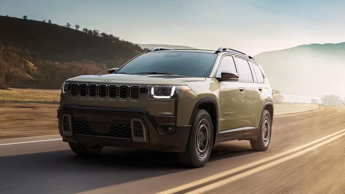 A Jeep Cherokee driving down a dusty highway