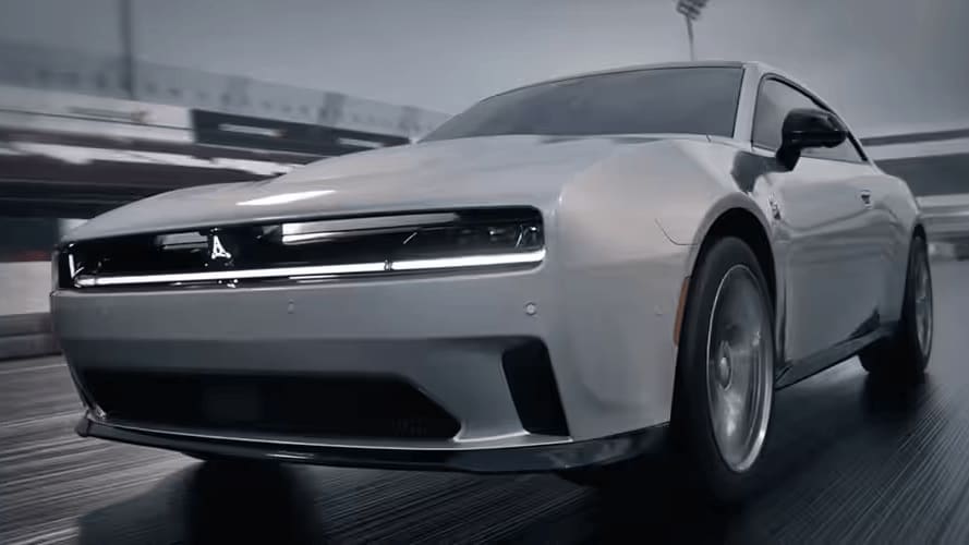 Learn about the 2025 Dodge Charger Daytona An action shot of the Dodge Charger Daytona driving down a track