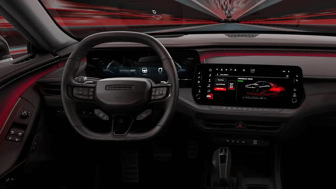 Learn about the 2025 Dodge Charger Daytona An interior shot of the Dodge Charger Daytona showing the steering wheel, dashboard/infotainment touchscreen console