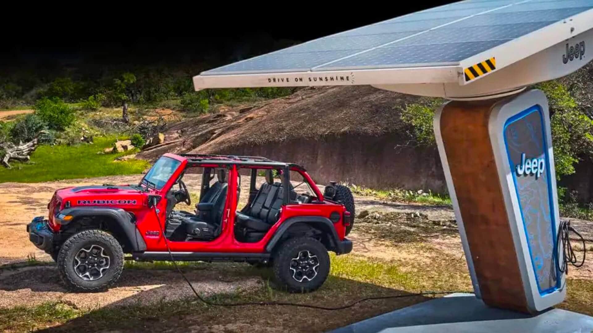 Jeep Wranger 4xe plugged into solar panel in the desert.