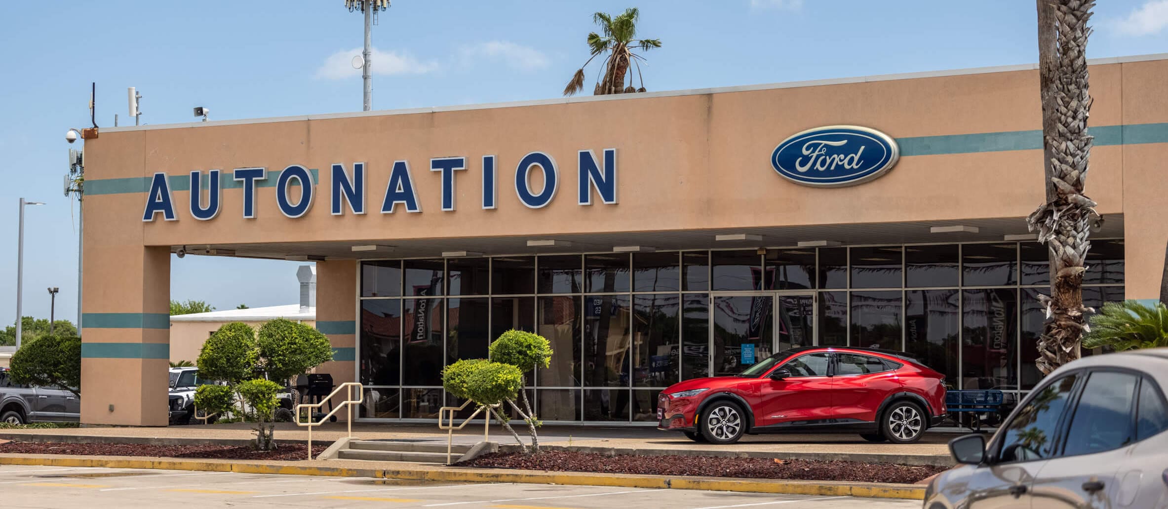 Autonation ford Corpus Christi exterior with red ford mustang parked near entrance