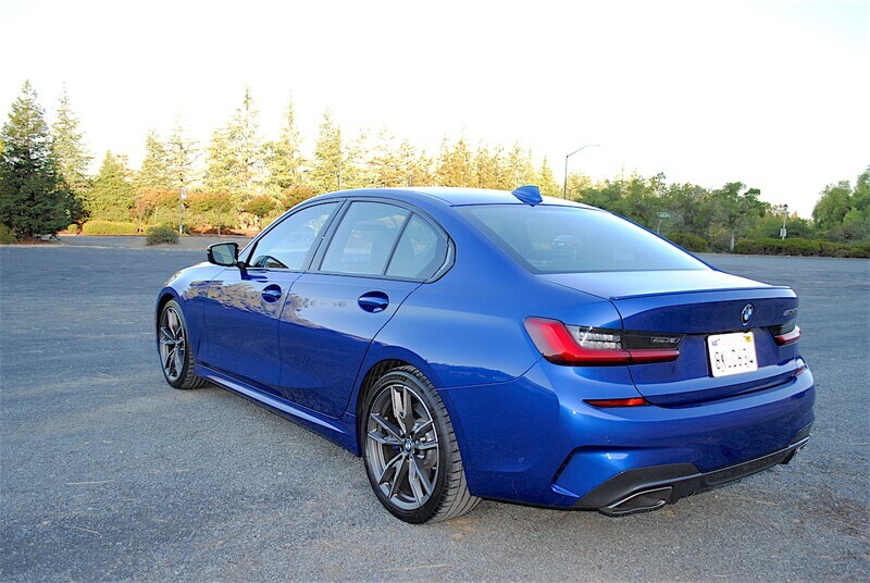 The rear of the M340i features a deck-lid mounted spoiler, twin exhaust tips, and special M340i badging.