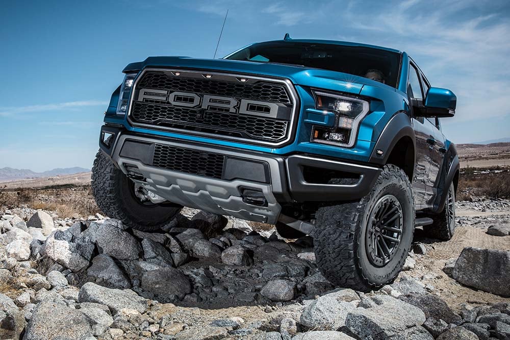 Ford F-150 Raptor driving across rugged surfaces