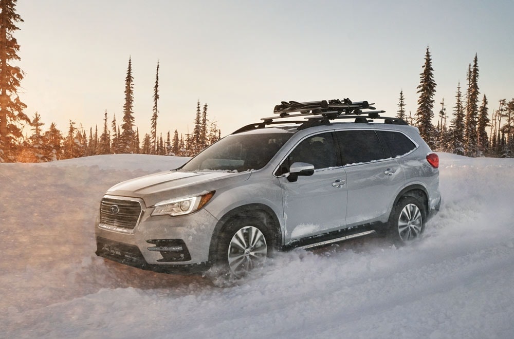 Image of a Subaru SUV driving through the snow