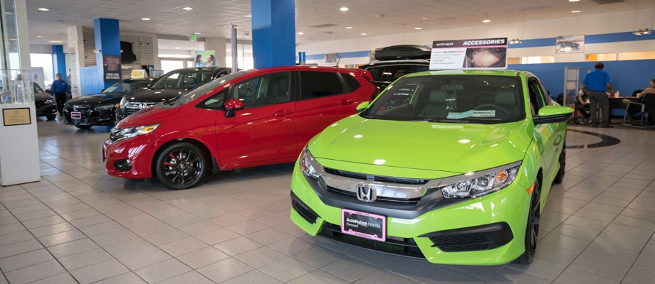 View of two Honda vehicles in Honda model showroom