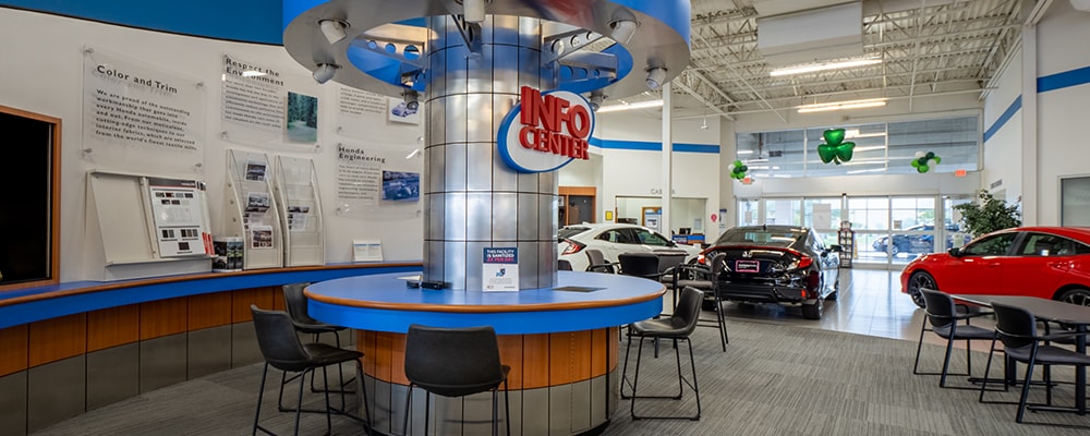 Interior view of AutoNation Honda Lewisville with tables and chairs in frame