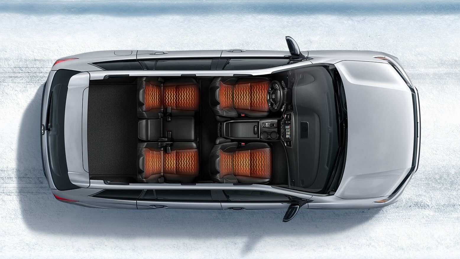 Learn which Honda models have heated seats, like the Honda Passport Elite. Top-down, interior shot of the Honda Passport Elite, illustrating that the front and rear seats have heating elements.