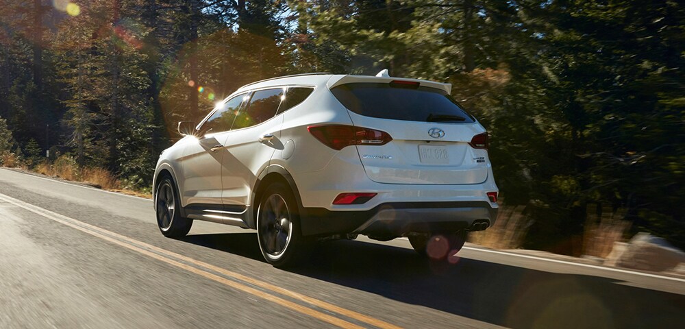 2018 Hyundai Santa Fe Sport For Sale Near Alpharetta Rear three-quarter view of 2018 Hyundai Santa Fe Sport in a forest.