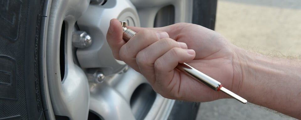 Checking tire pressure with a gauge