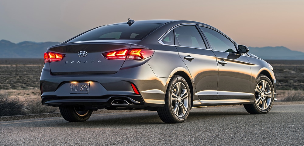 2018 Hyundai Sonata For Sale Near Chandler Rear three-quarter view of 2018 Hyundai Sonata in a sunset.