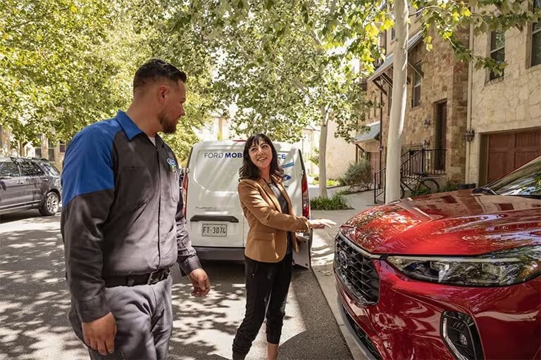 Ford Technician meeting with a customer at their house