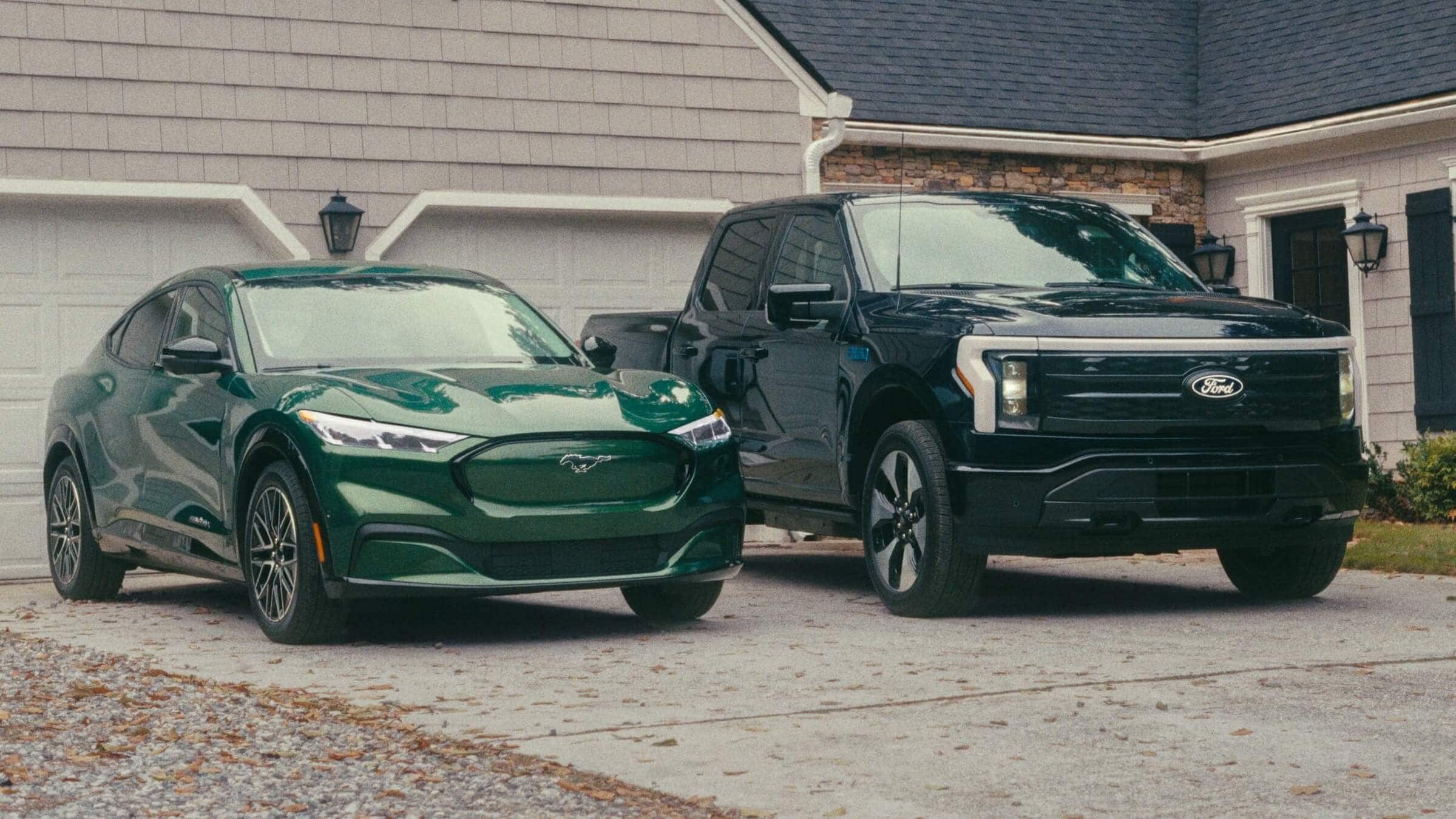 Exterior shot of a Ford Mustang Mach-E and a Ford F-150 Lighting parked outside a house