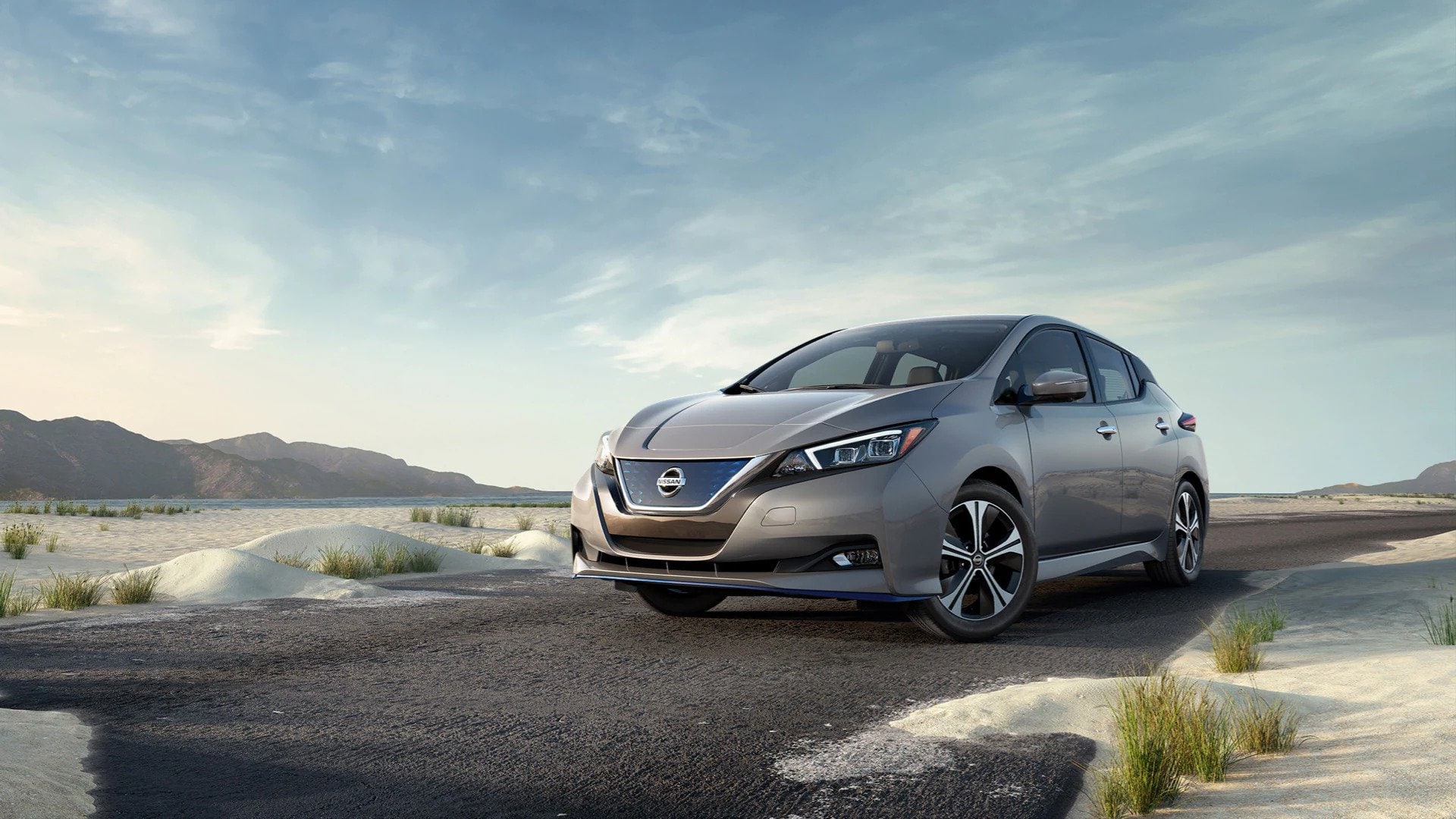 Gray Nissan Leaf driving in the desert