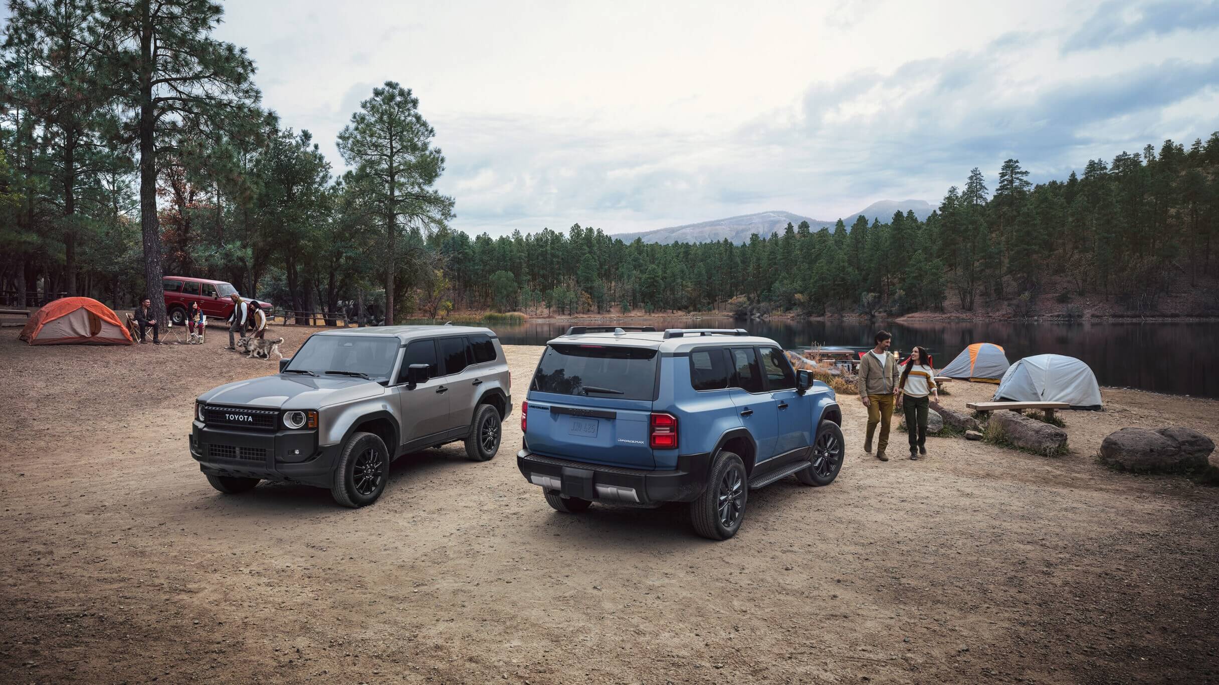 Two Toyota Land Cruiser SUVs parked at a camp site, showing Meteor Shower and Heritage Blue