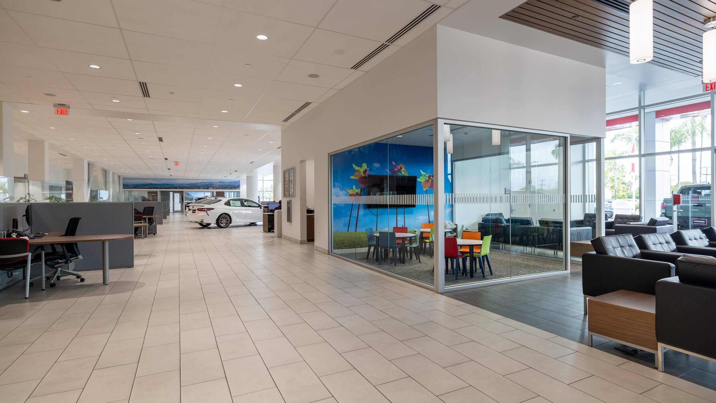 Find out about buying, servicing, and financing Toyota vehicles at AutoNation Toyota Buena Park Interior shot of AutoNation Toyota Buena Park, showing desks, lounge area, and kids play area.