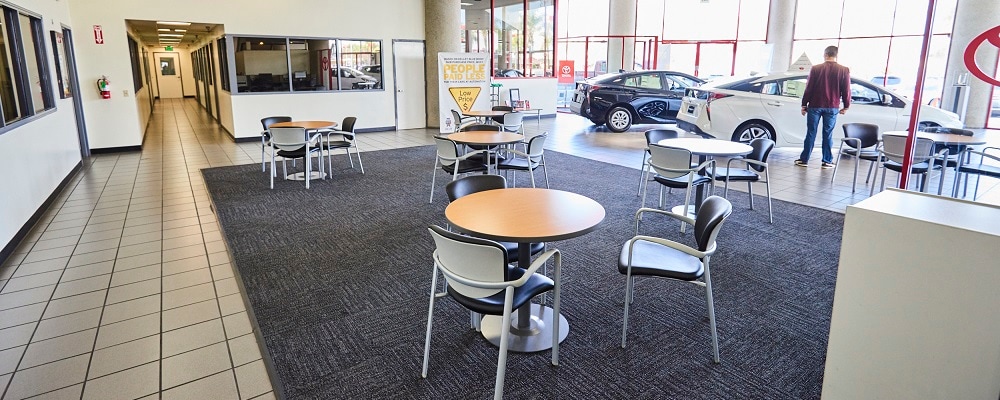 White Toyota parked in the lobby of AutoNation Toyota Cerritos