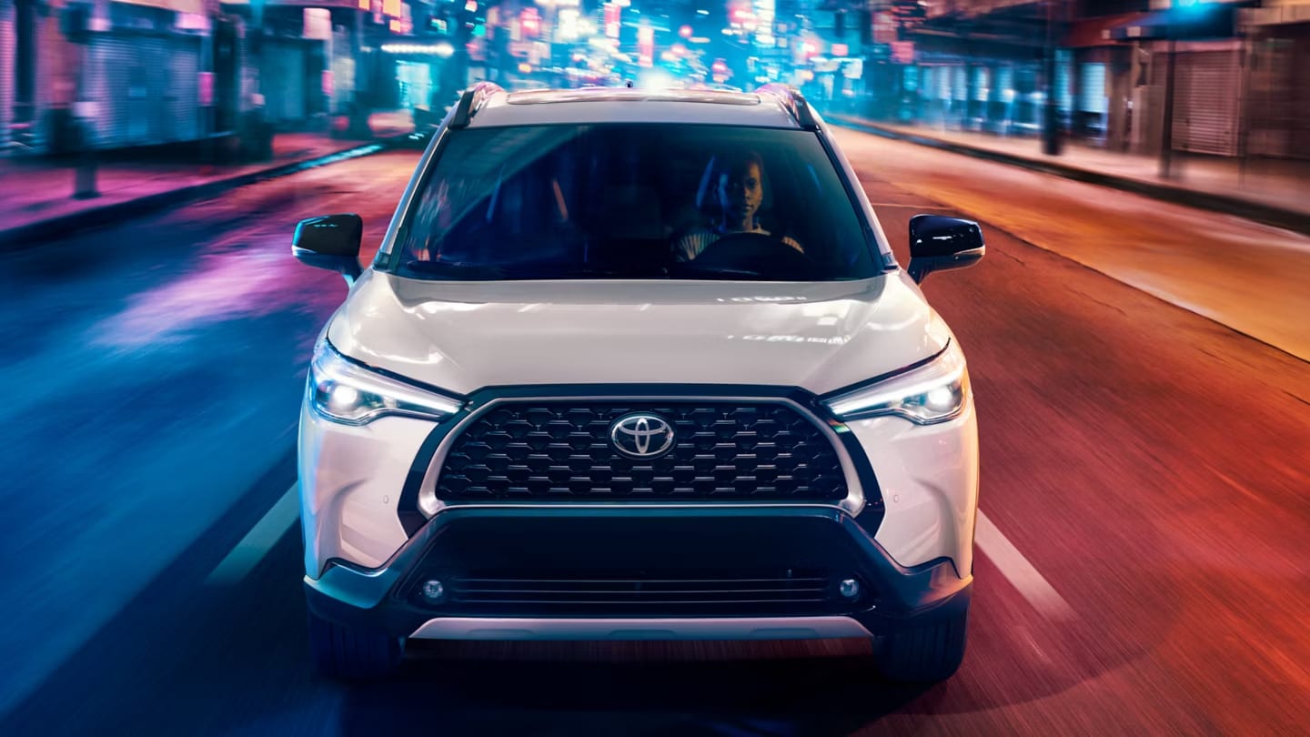 Toyota Corolla Cross in bright lights driving at night